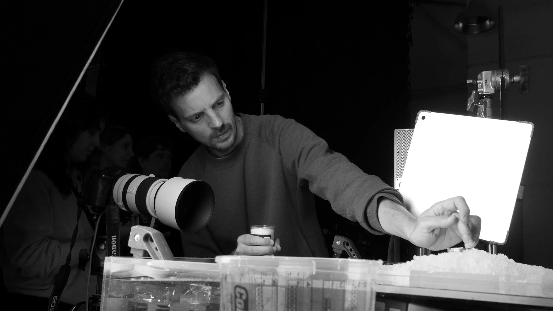 Tasty Studio tabletop artist placing a product on crushed ice in front of a macro lens