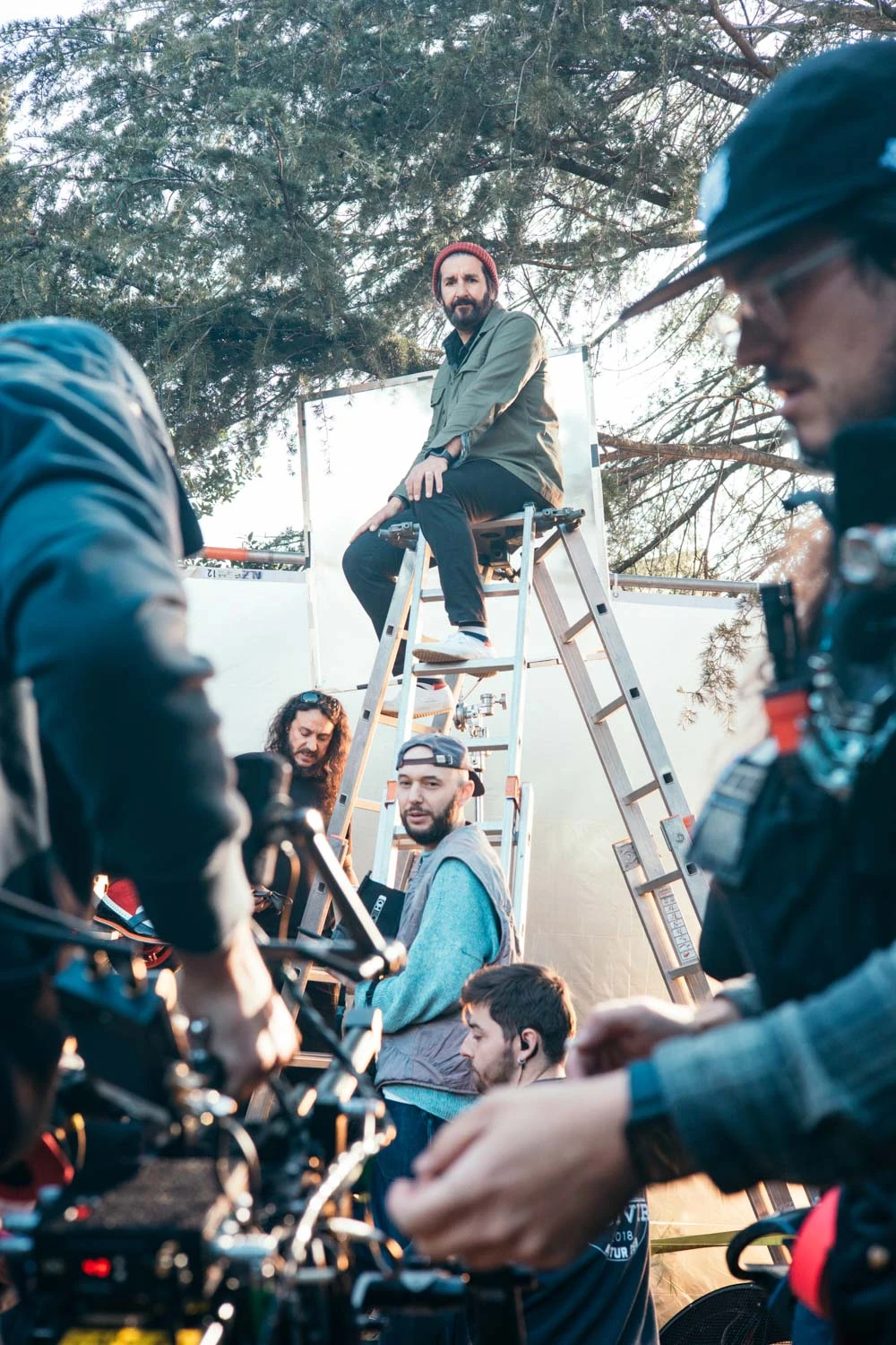 Glassy Films camera crew at work, with a crew member sitting on a ladder behind